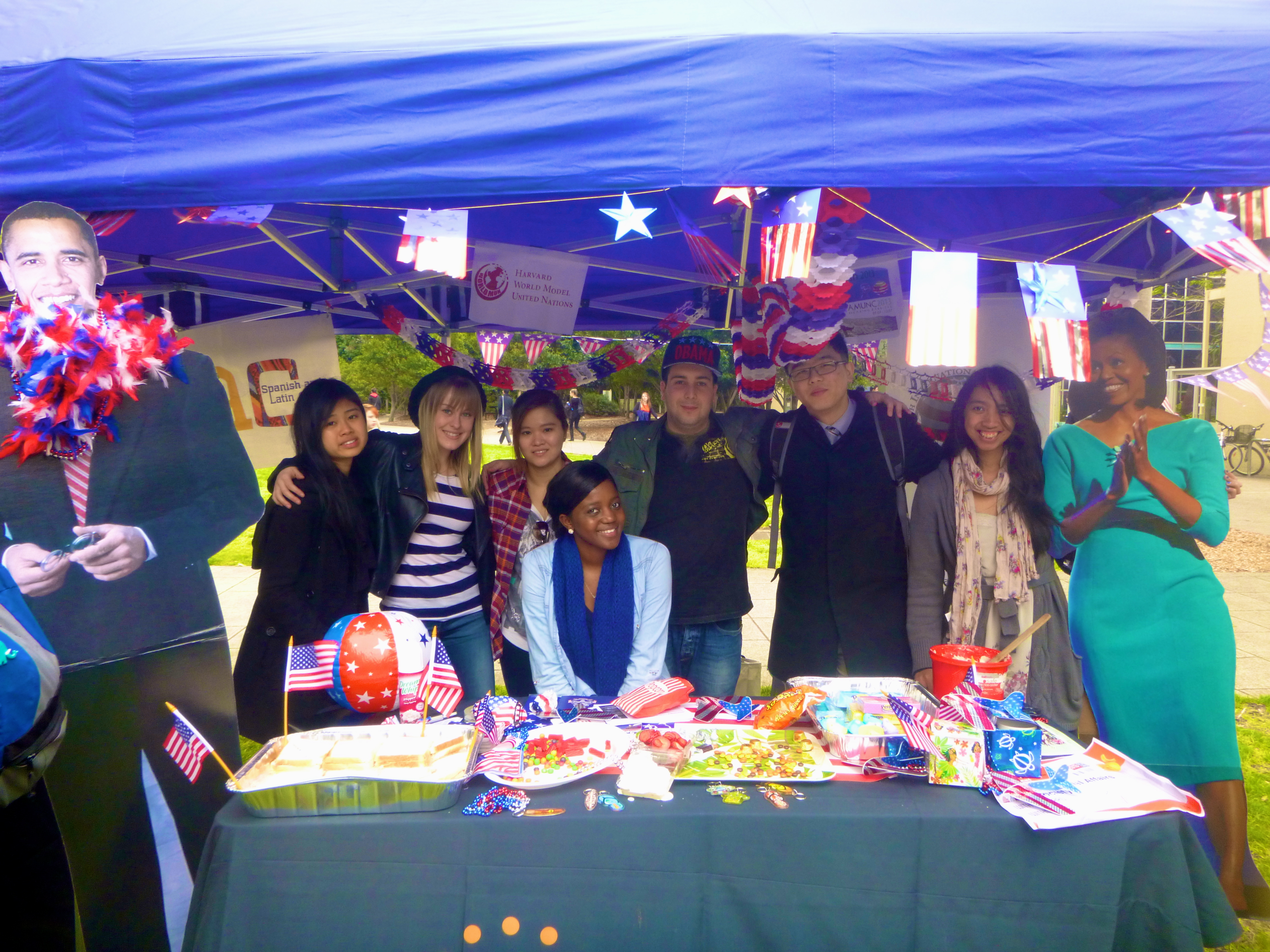 MIAS Volunteers posing with stall and life-size Obama cutouts